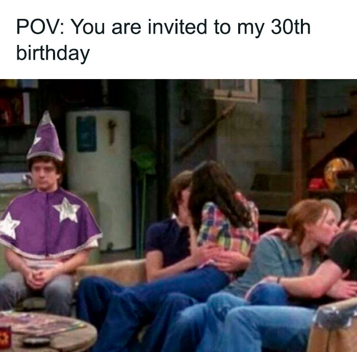 Wizard costume at 30th birthday party with couples kissing on the couch, a funny meme for celebration fun.