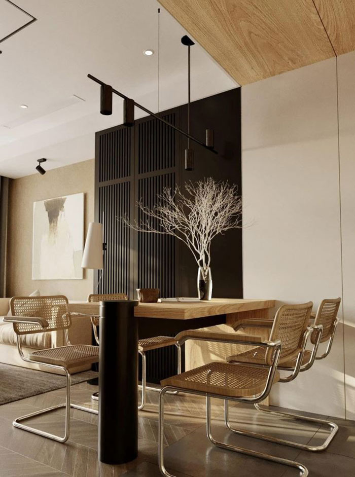 Dining area featuring boho decor with a wooden table, woven chairs, and a minimalist vase centerpiece for a chic space.