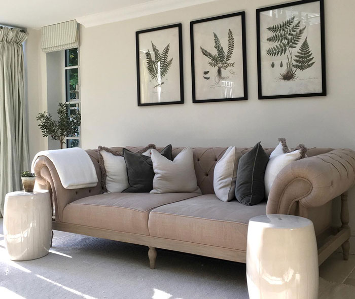 Off white large tufted couch with multiple pillows in a bright living area, showcasing a budget-friendly cheap couch option. Off white large tufted couch with multiple pillows in a bright living area, showcasing a budget-friendly cheap couch option.