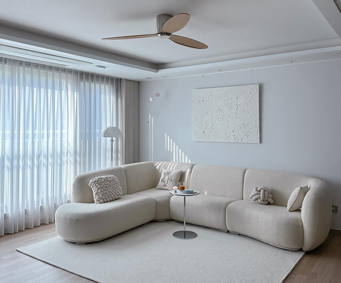 White rounded corner sofa in a bright living room showcasing a stylish and affordable cheap couch design. White rounded corner sofa in a bright living room showcasing a stylish and affordable cheap couch design.