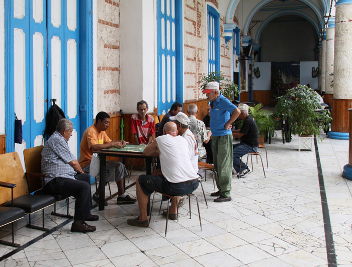 Men playing dominoes on a Havana street, showcasing culture facts reflecting the diversity and beauty of the world.