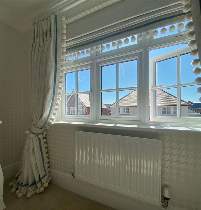 curtains on the window with pom pom tassels