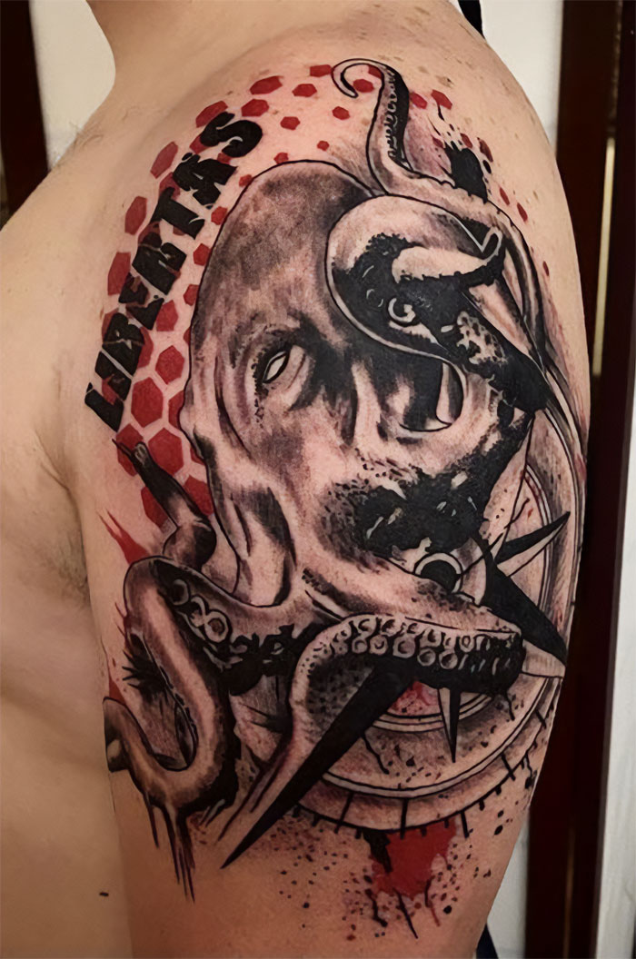 Trash Polka tattoo of an octopus with text "Libertas" on a person's arm, featuring bold red and black patterns.