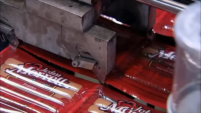 Packaging process of popular hot dogs revealing disturbing behind-the-scenes secrets about this popular meal worldwide