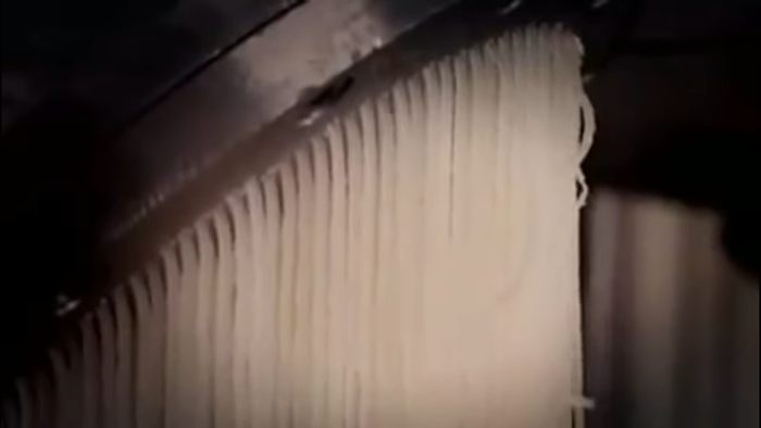 Close-up of noodles being produced, revealing disturbing behind-the-scenes secrets about popular meals worldwide.
