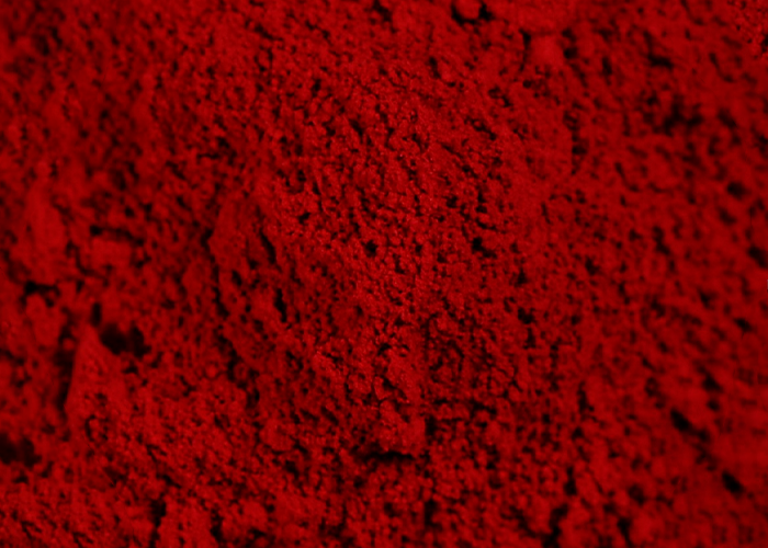 Close-up of vibrant red spice powder, highlighting textures related to popular meals and behind-the-scenes secrets.