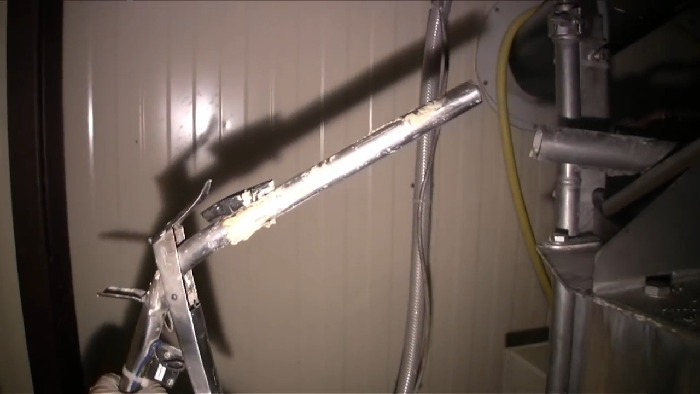 Close-up of a metal tool used in food processing, revealing disturbing behind-the-scenes secrets of popular meals.