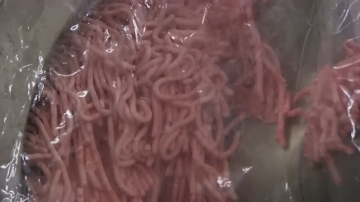 Close-up of packaged raw ground meat revealing disturbing behind-the-scenes secrets of popular meals worldwide.