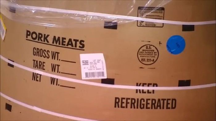 Cardboard packaging for pork meats with inspection stamp, wrapped in plastic, revealing behind-the-scenes meal secrets.