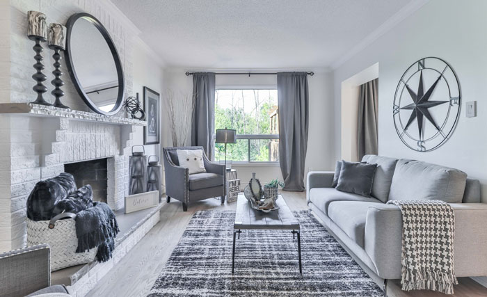 White living room featuring a white painted fireplace mantel with modern decor and cozy seating arrangements.