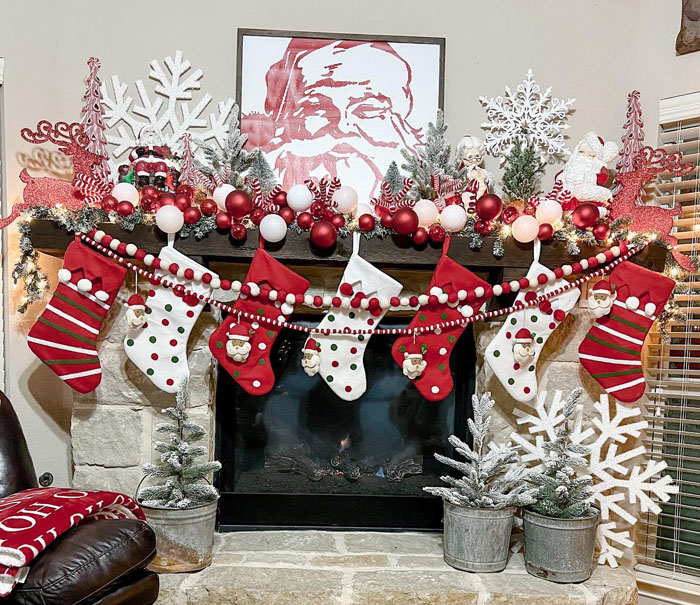 Christmas themed living room fireplace mantel with stockings, garlands, and festive decorations for cozy hearth ideas