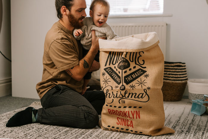 A man opens presents with a child 