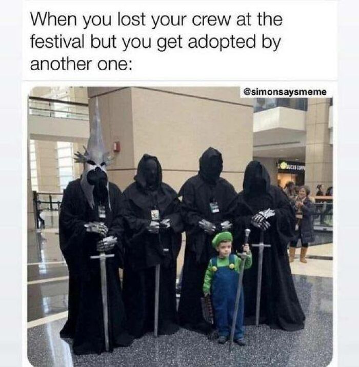 Child dressed as Luigi stands with four people in Middle Earth-themed costumes, holding swords.