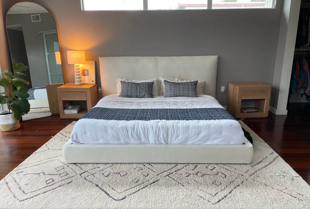Ivory carpet and bed near the gray wall