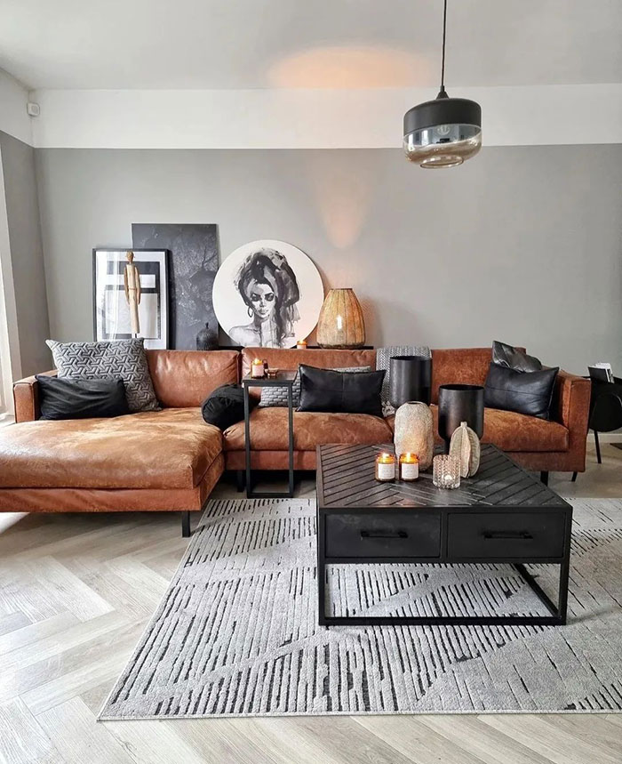Modern living room with brown accent details, black cushions, contemporary art, and stylish home decor ideas for a cozy space.