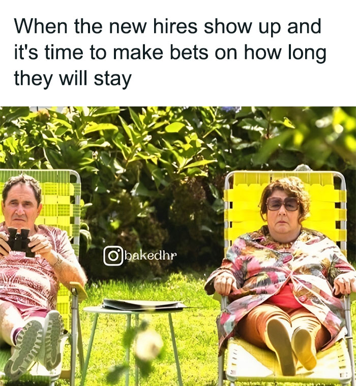 Two HR ladies lounging outside with binoculars, humorously observing new hires.