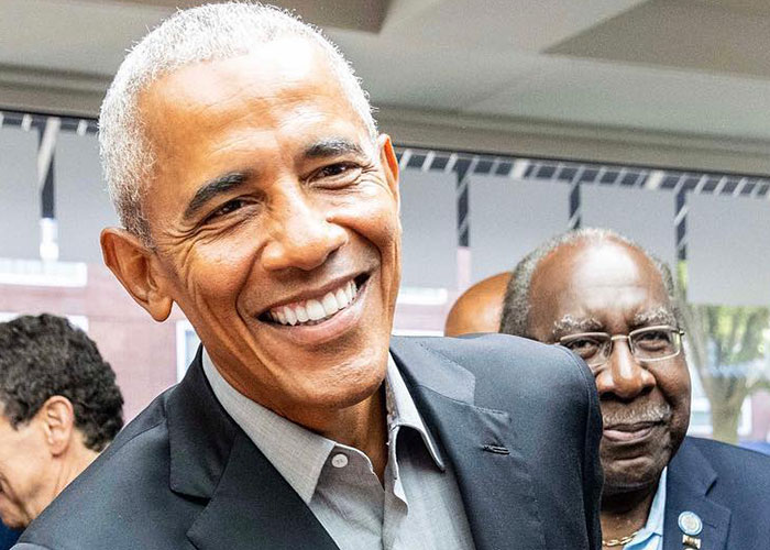 Smiling older man with gray hair and wrinkles wearing a dark suit, illustrating signs that make people look older.