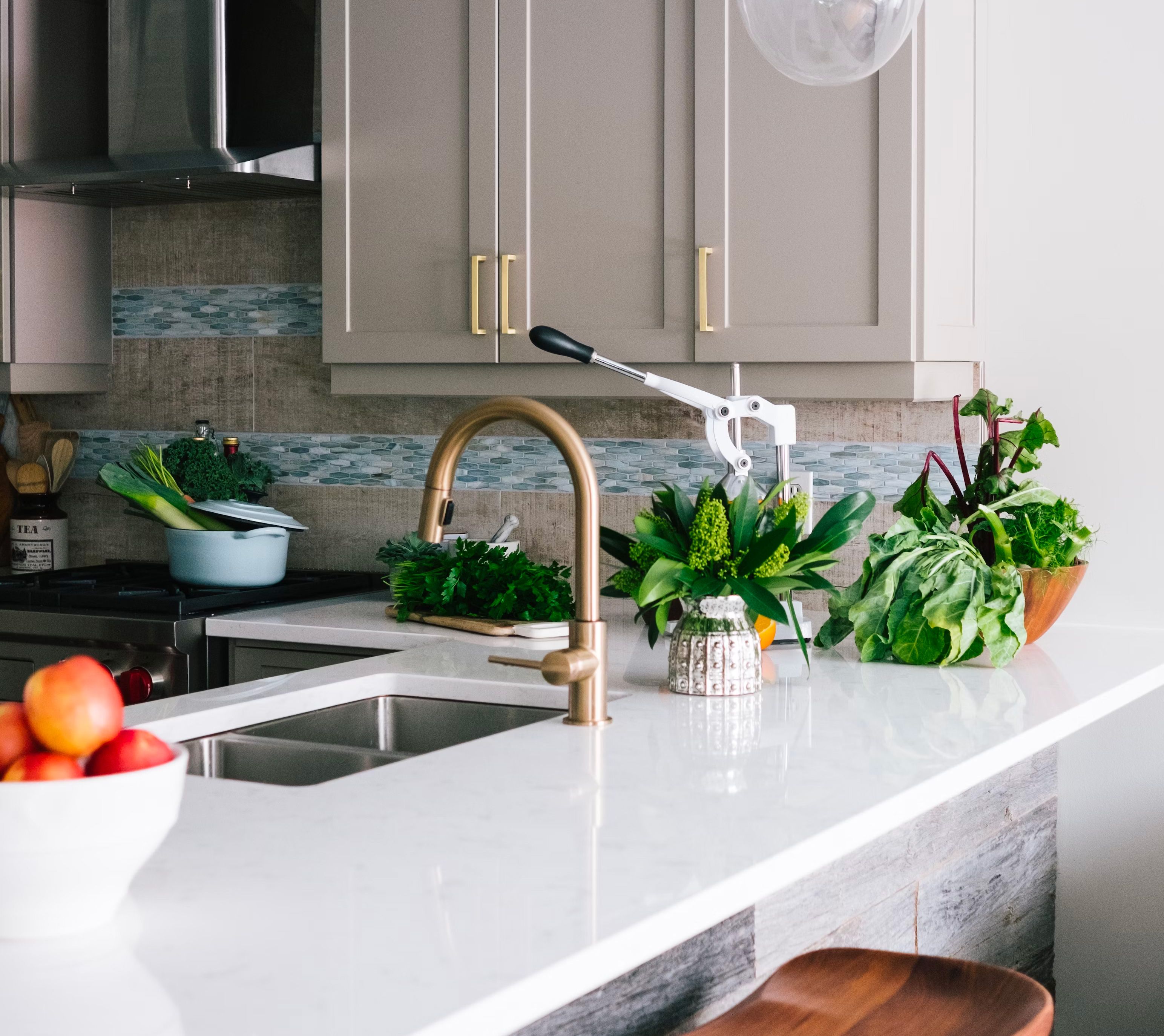 kitchen with gray cabinets and white countertops with vegetables on it 