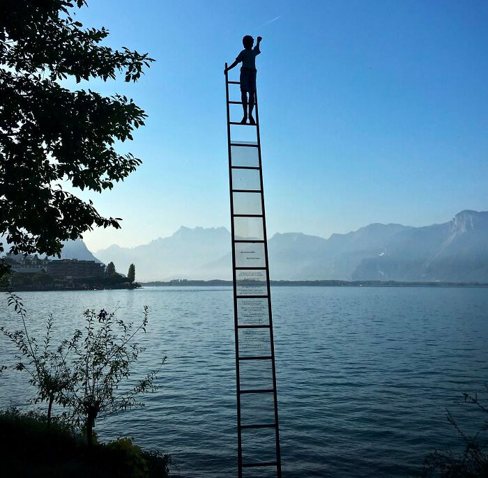 Boy on stairs reaching sky