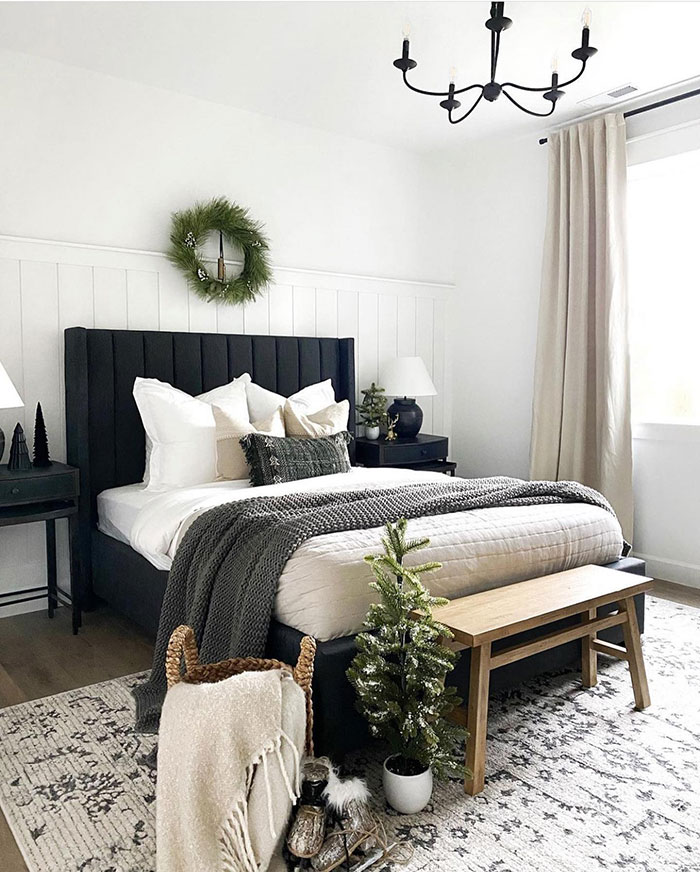 Cozy black and white master bedroom with modern design, textured bedding, and natural wood accents for stylish comfort.