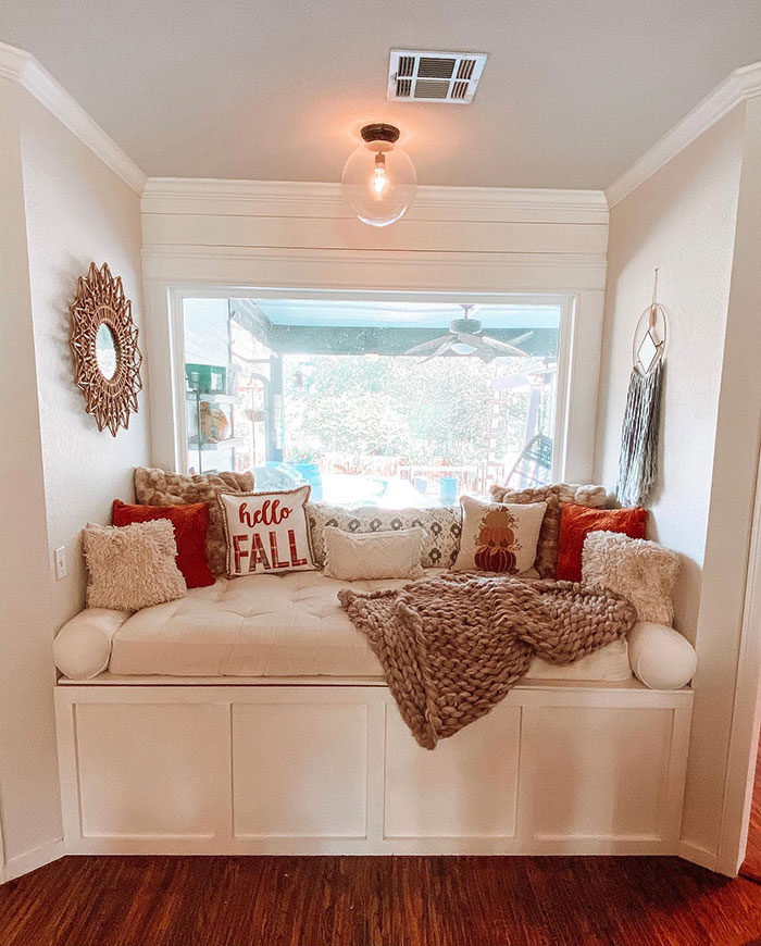 Bright warm window nook with cozy cushions and a chunky knit throw, perfect for master bedroom ideas and design inspiration.
