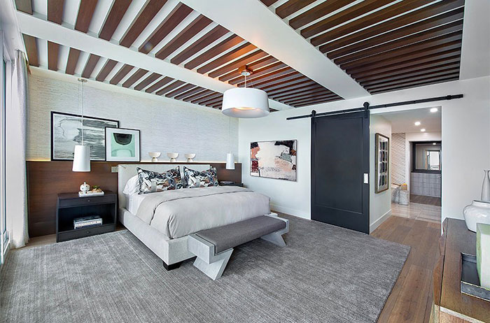 Spacious bright master bedroom ideas featuring a unique wooden slatted ceiling and modern minimalist design.