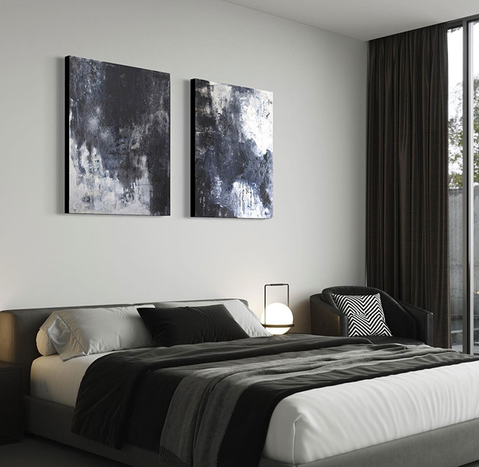 Dark master bedroom with modern art pieces, minimalist design, and cozy black and gray bedding for stylish interior ideas.