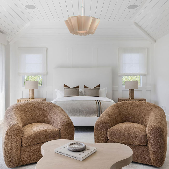 White master bedroom featuring cozy brown chairs, a modern bed, and minimalist decor showcasing master bedroom ideas.