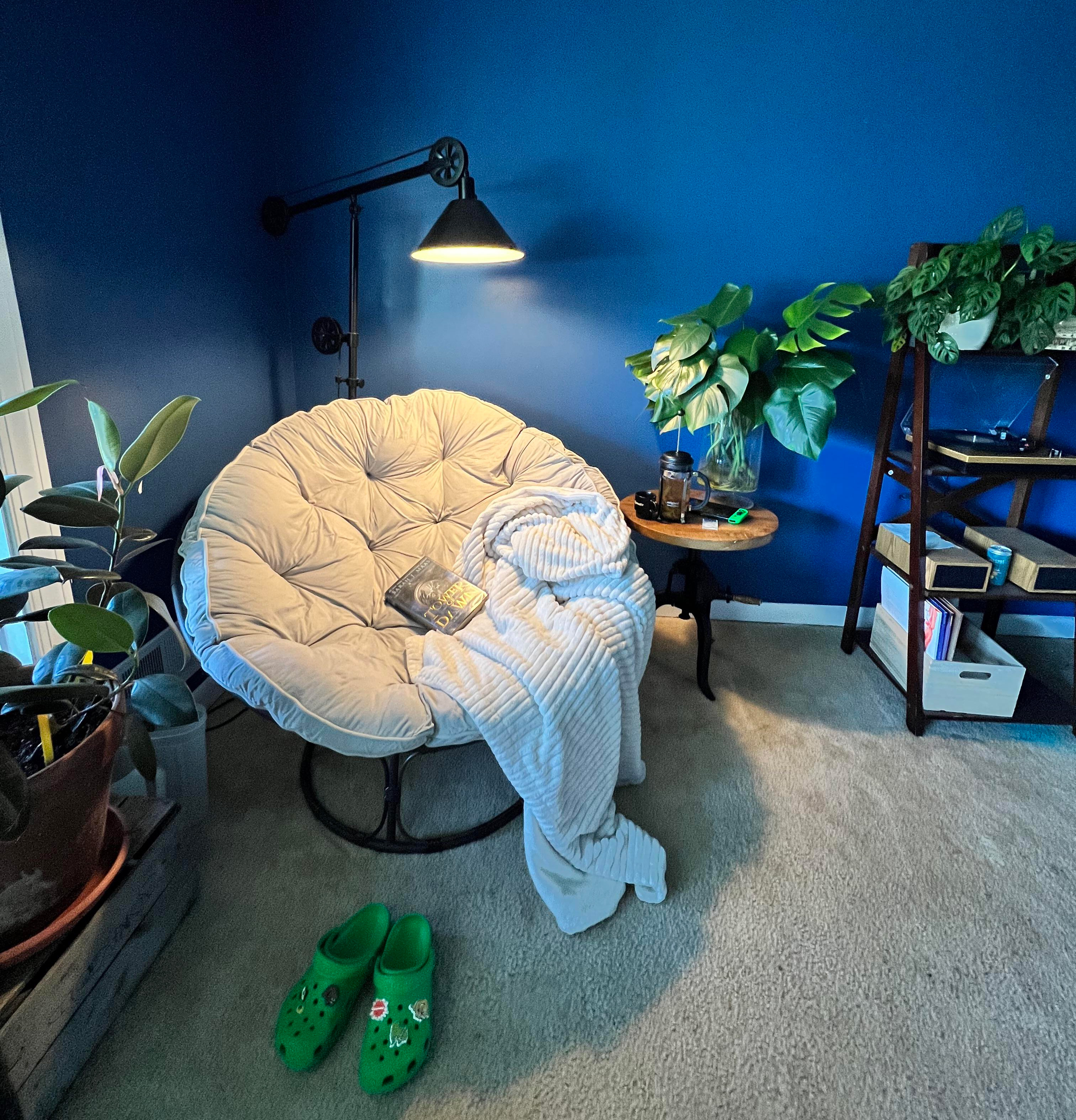 big rounded chair on the background of blue wall