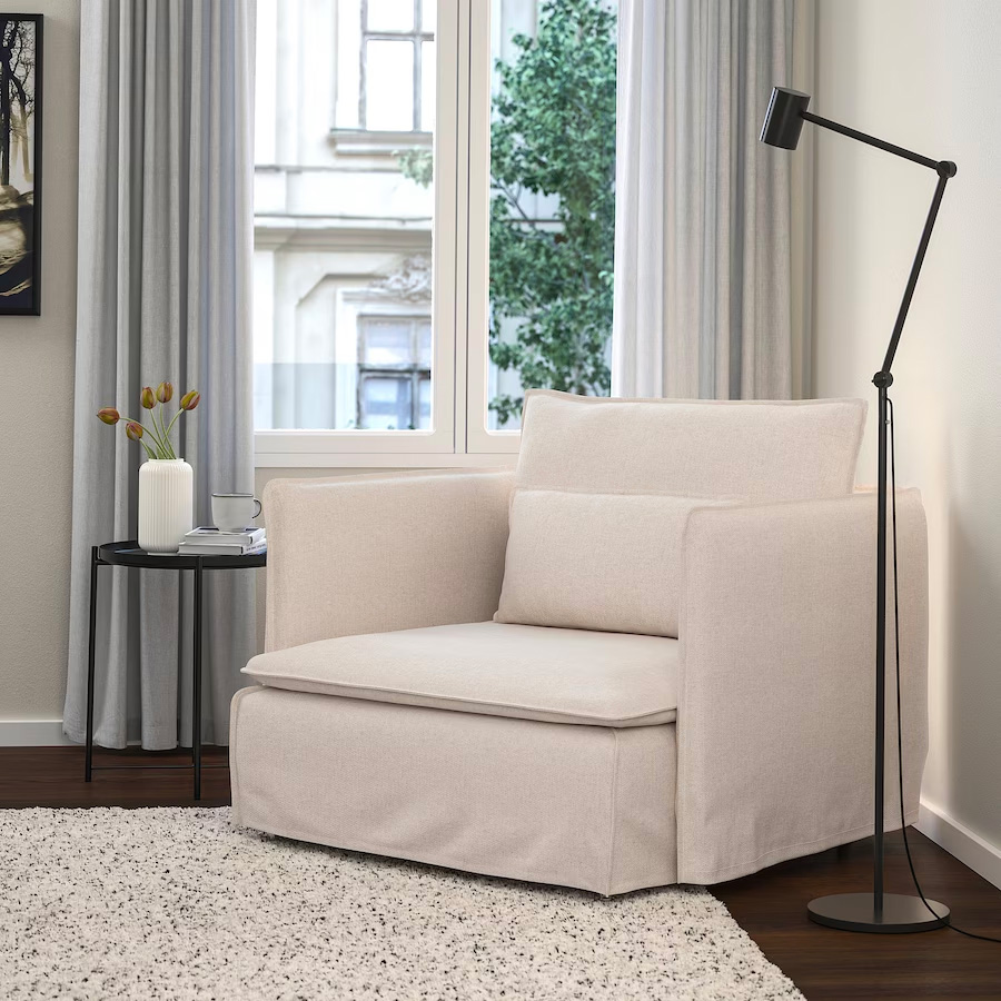 natural color armchair near the window