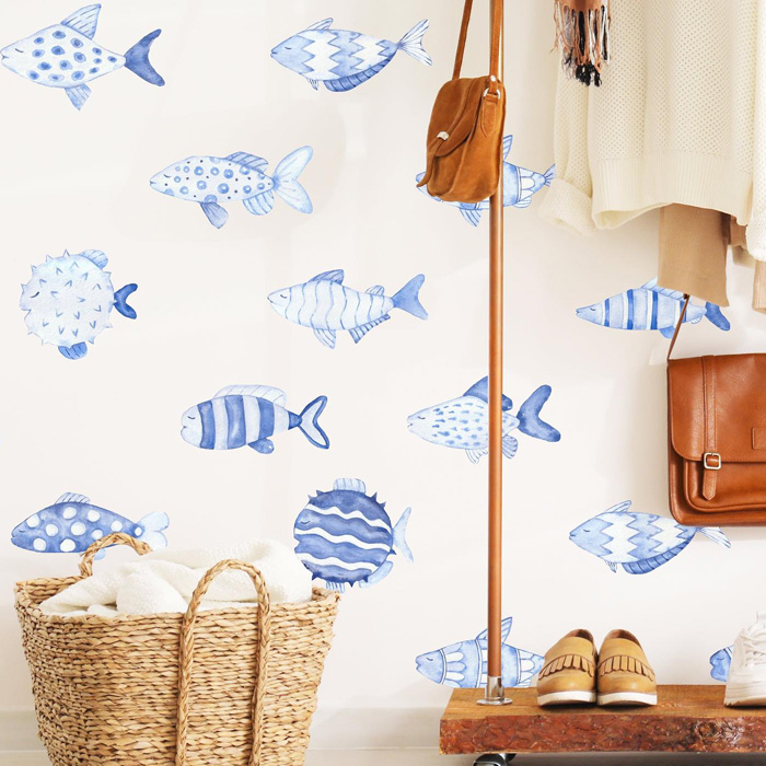Blue fish patterned removable wallpaper in a cozy entryway with basket, shoes, and hanging bags decor.