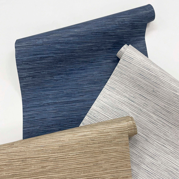 Rolls of stylish removable wallpaper in blue, white, and beige with textured horizontal stripe patterns on white background