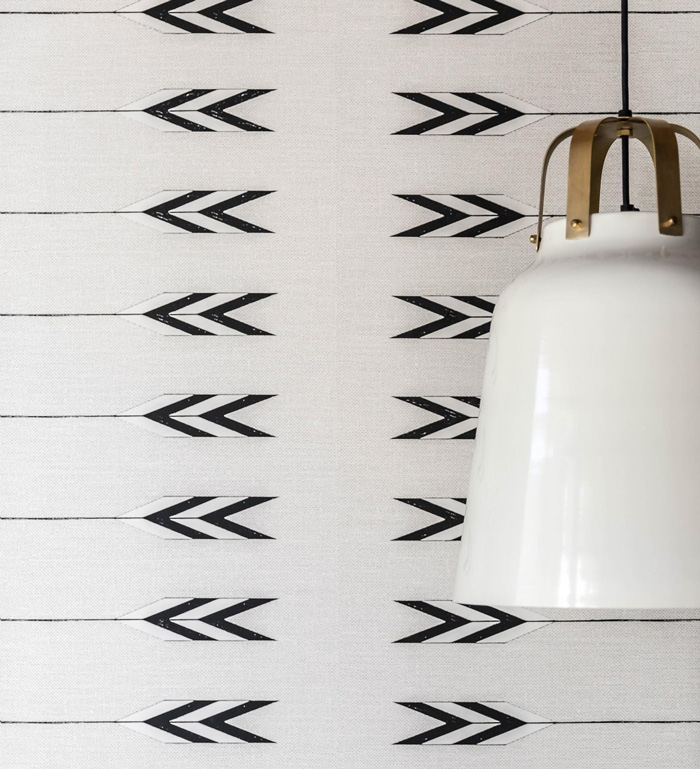 White removable wallpaper with black arrow patterns paired with a modern hanging lamp for stylish decor ideas.