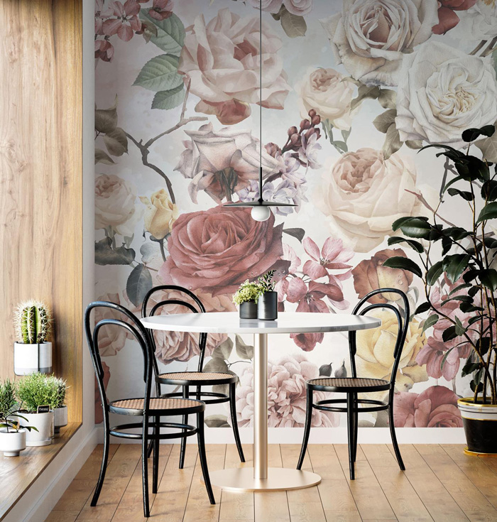 Dining room with stylish removable wallpaper featuring large floral patterns and modern black chairs.