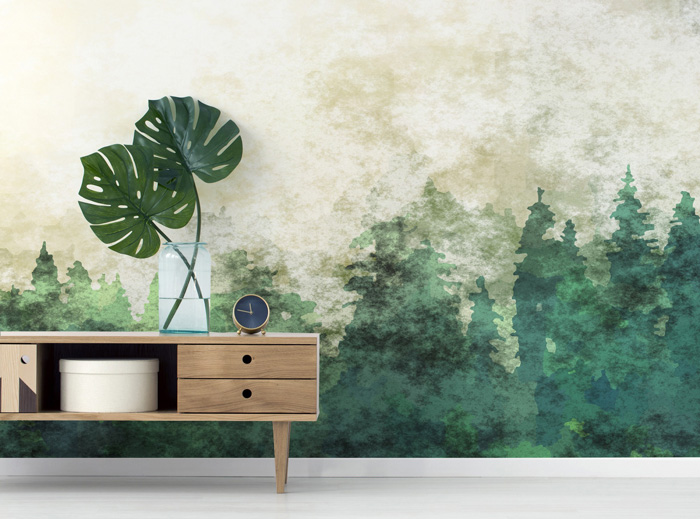 Abstract forest removable wallpaper in a modern room with a wooden console and green decorative leaves.