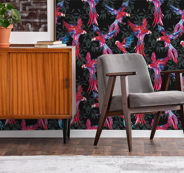 Stylish removable wallpaper with vibrant pink parrots on black background in a modern living space.