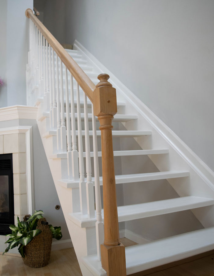 white floating stairs with wooden railings