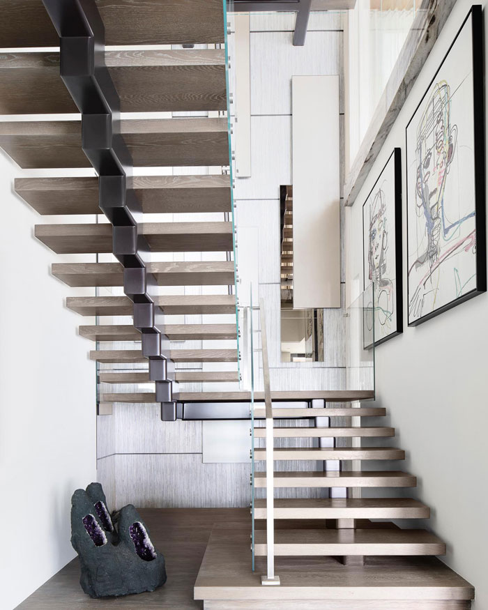 floating wooden staircase between white walls