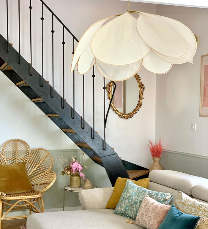 wooden stairs with black metal railings in a cozy room