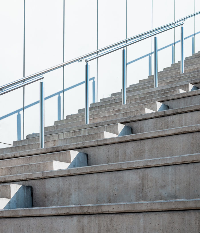 gray concrete staircase with metal railings