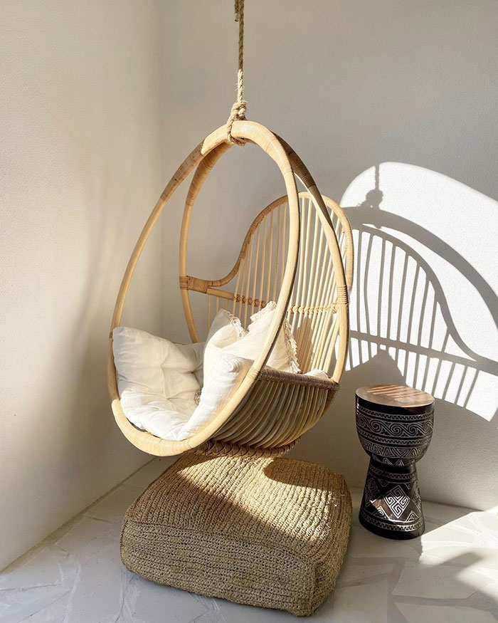 Bright Playful Sunroom With Rattan Swing Chair In A Corner Bright Playful Sunroom With Rattan Swing Chair In A Corner