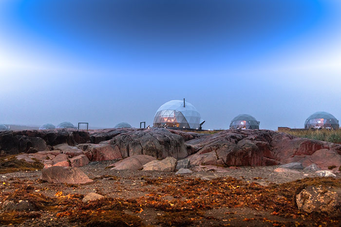 The dome homes on top of a rocky hillside.