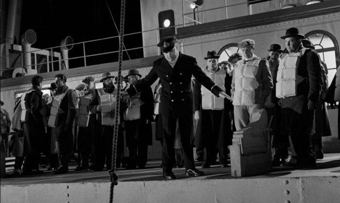 People standing on the edge of the Titanic with life jackets in the movie 'A Night to Remember' (1958) 