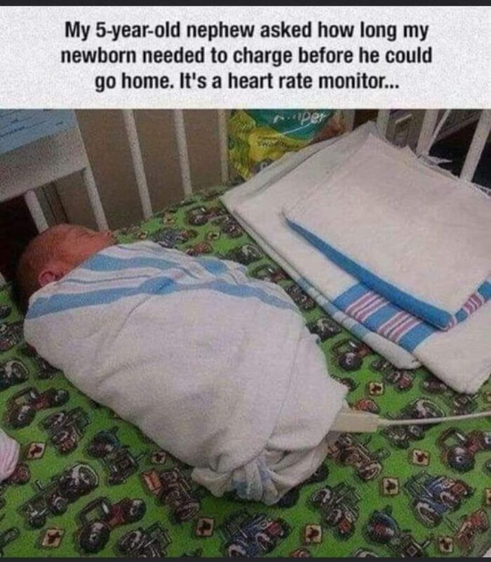 Baby wrapped in a hospital crib with a funny engineering meme about charging and a heart rate monitor.