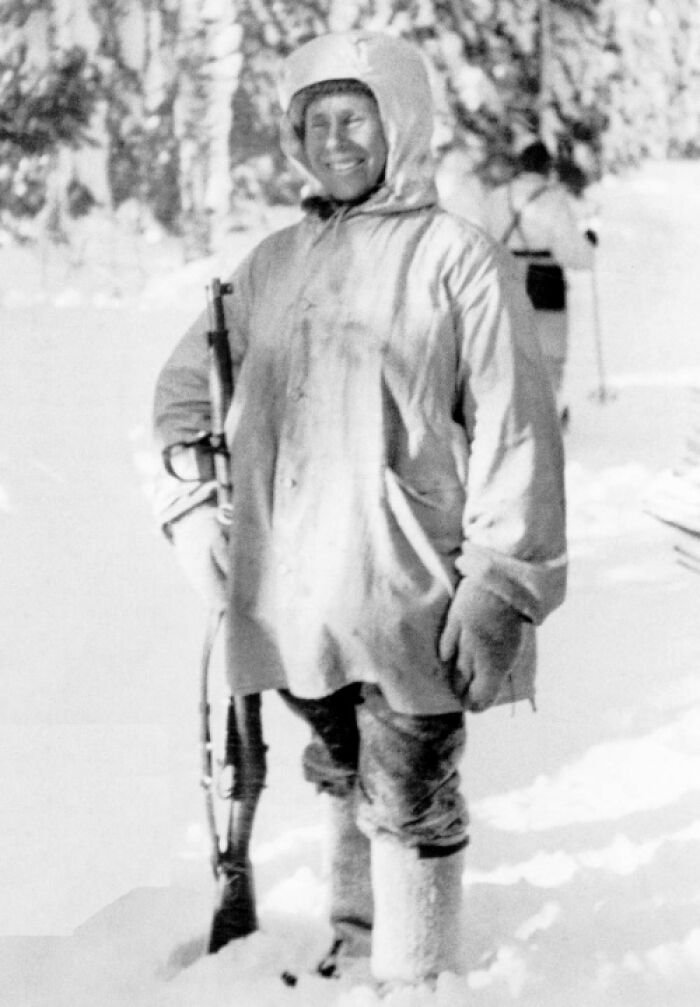 Person in winter gear holding a rifle outdoors in snow representing coolest person to have ever lived.