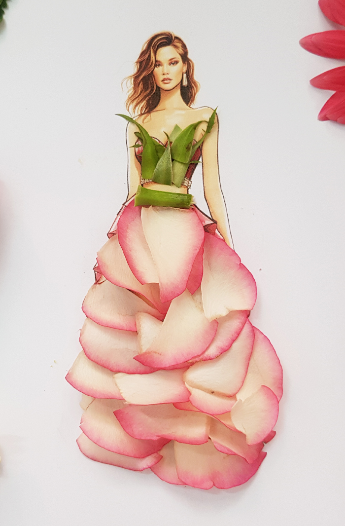 A drawing of a woman dressed in real flower petal gown