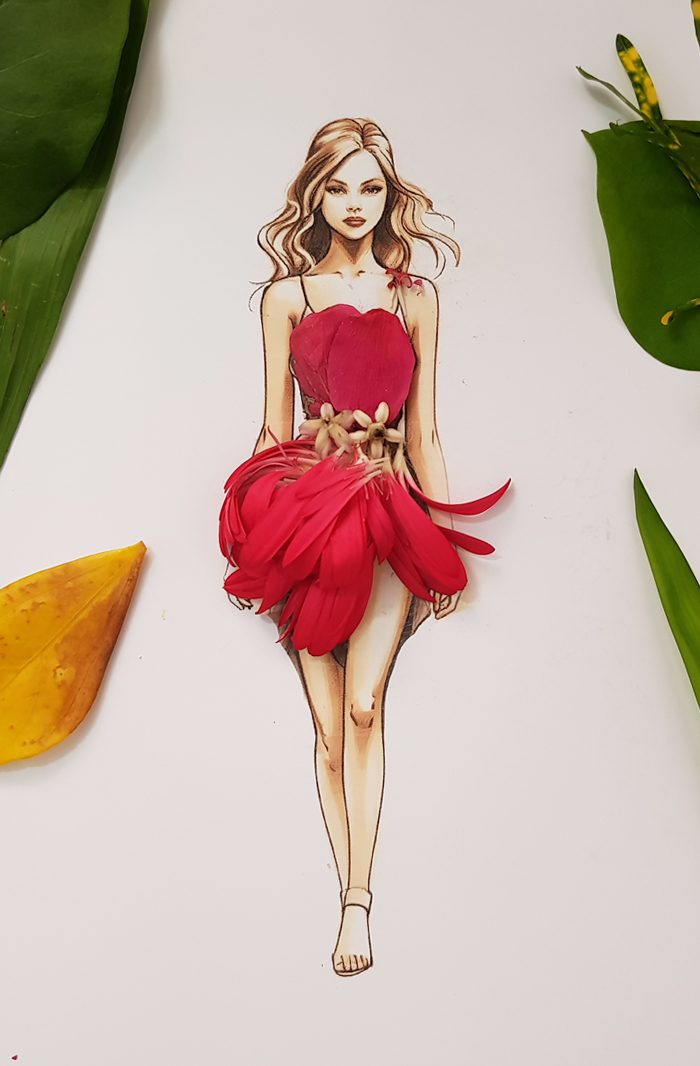 A drawing of a woman dressed in real flower petal gown