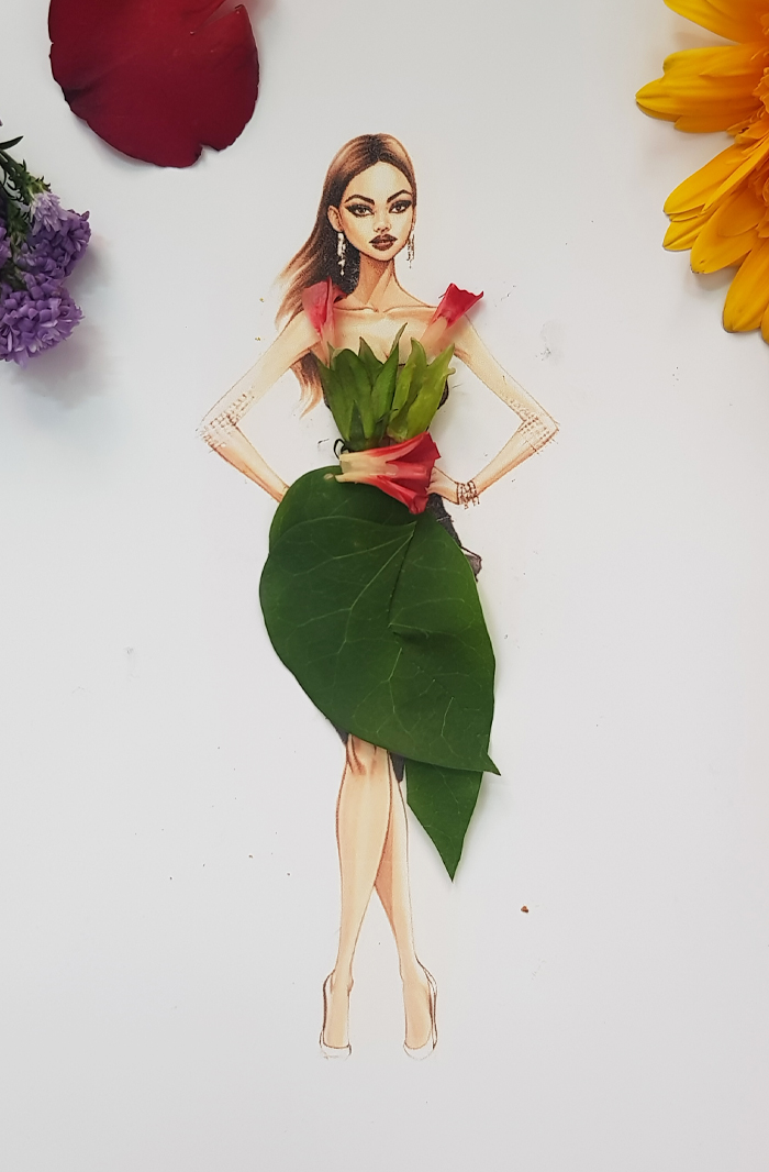 A drawing of a woman dressed in real flower petal gown