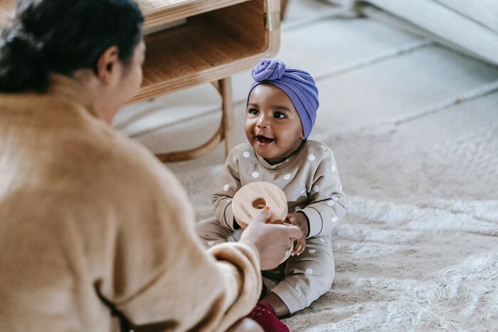 Mother and baby sharing a joyful moment indoors illustrating unspoken mom code and maternal connection.