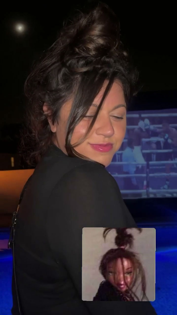 A woman dressed for a meme-themed party, mimicking a meme with her hairstyle and pose.